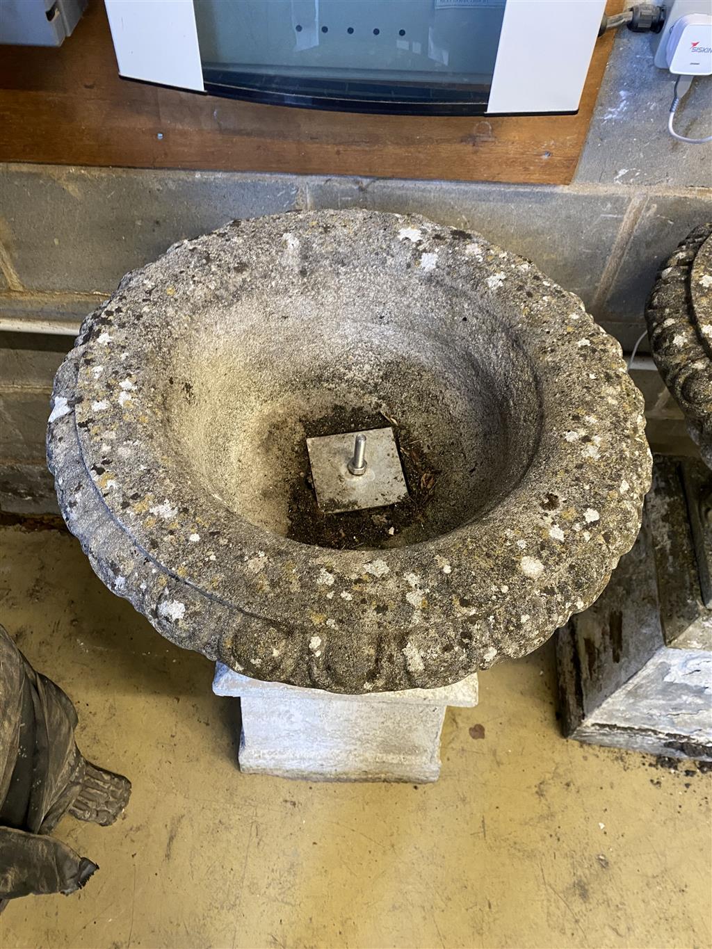 A pair of reconstituted stone campana garden urns and pedestals, 56cm diameter, height 99cm